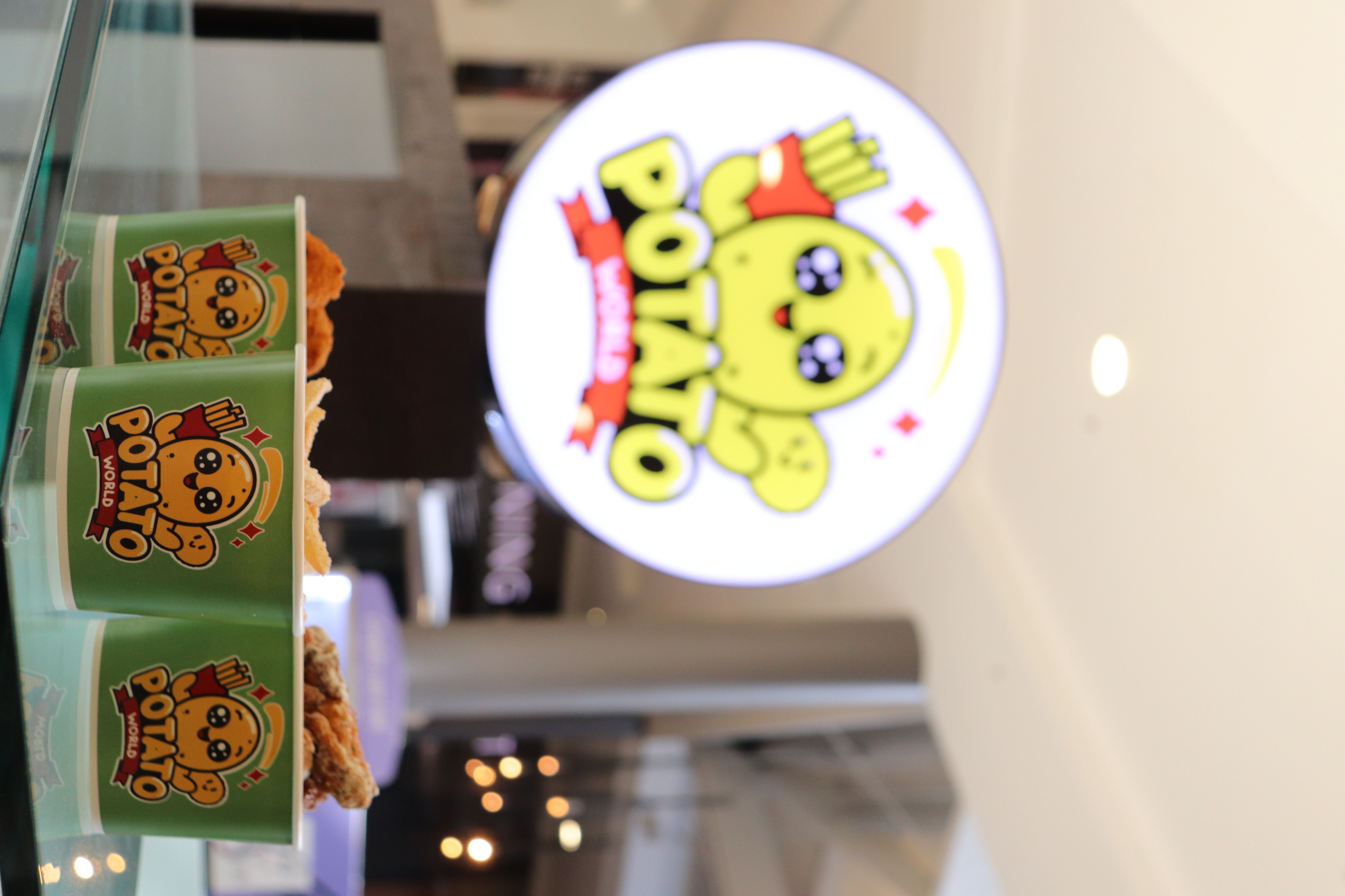 Potato World kiosk with branded cups and logo sign